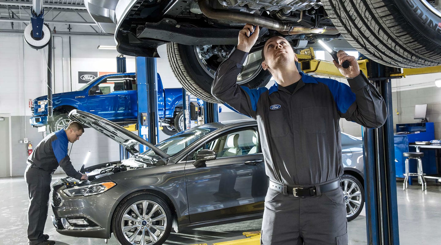 A technician servicing a car